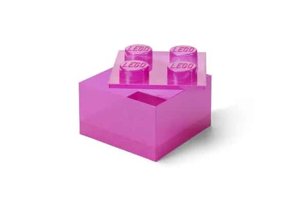 Roze doorzichtige opbergdoos in de vorm van een steen